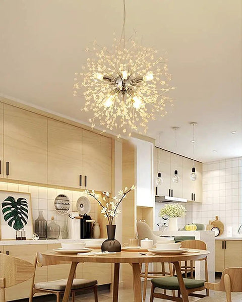 Modern kitchen with 9 Light Chrome Crystal Dandelion Firework Chandelier With Adjustable 78 Inch Cord glowing above dining table