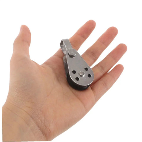 Person holding Stainless Steel Single Pulley Block Set For Rope Sailing Kayak Boat Hardware Four Piece Marine Bearing Wheel Kit