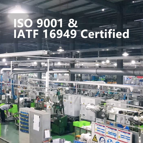 Industrial manufacturing facility with ISO 9001 and IATF 16949 certification banner above machinery and equipment.
