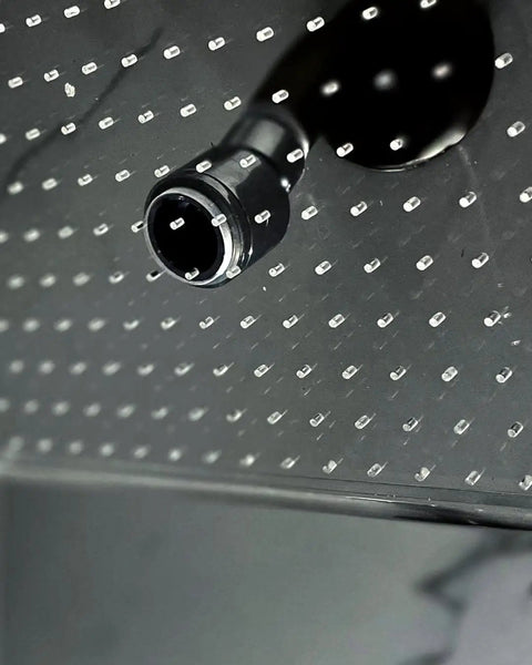 Close-up of ceiling mounted rain shower with single jet, glass and acrylic construction, modern frameless design