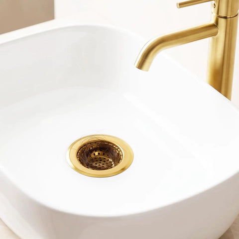 Heavy Duty Stainless Steel Bathroom Sink Strainers 2 Pack Anti Clog Mesh Drain Screen in gold finish catching hair in white sink.