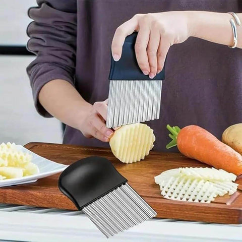 Crinkle cutter with a black handle and stainless steel blades slicing a potato on a cutting board.