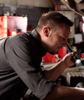 Mechanic using the Stinger Classic 500 Lumen LED Rechargeable Flashlight With 120V AC DC Charger And Two Holders on engine