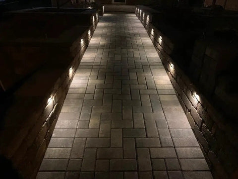 Aluminum Recessed LED Lights Kit 16 Pack 1.02 Inch 26 Millimeter Outdoor Deck Stair Lights illuminating a brick walkway at night