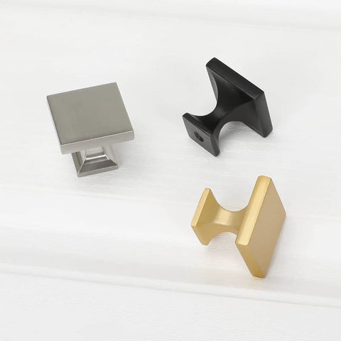 Three square cabinet knobs in gold, silver, and black showcasing the 5 Pack Matte Black Square Cabinet Knobs For Kitchen And Bath Zinc Alloy Hardware Handles And Drawer Pulls Durable Build With A Slick Dope Finish Easy Install And Long Lasting design
