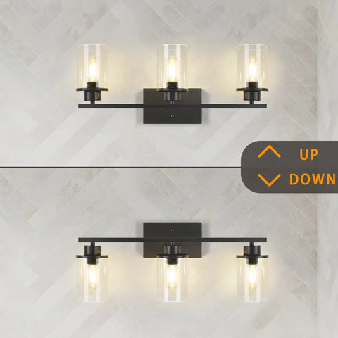 Slick Black 3 Light Vanity Light Fixtures Over Mirror With Clear Glass Shades mounted on wall, modern industrial farmhouse style
