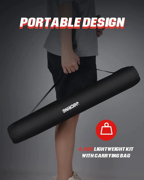 Person holding Cordless Rechargeable LED Work Light Kit With Detachable Tripod in black carry bag, highlighting portability.