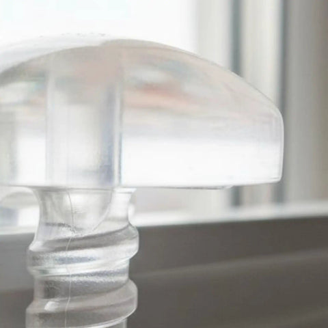 Premium Drapery Track Stoppers Keep Your Curtains Locked Down Totally Slip Free Tough Snap Install For Narrow Window Channels close-up view of a clear plastic curtain track stopper.