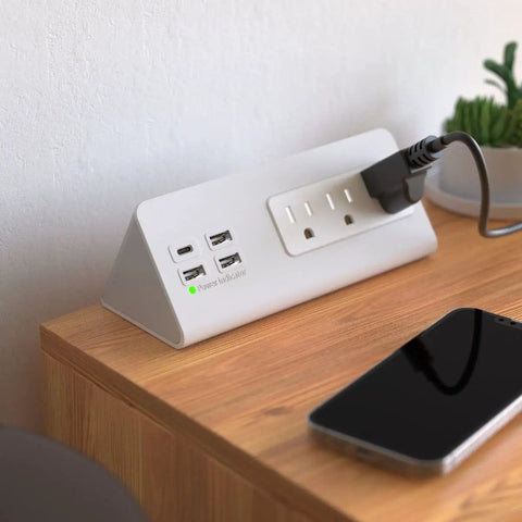 Edge Mount Power Strip With USB-C Ports And 4 Fast-Charging USB Ports, Desk Clamp Surge Protector on wooden desk with device plugged in.