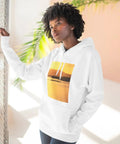 Woman wearing Outrigger Canoe Sunset Molokai Hawaii Inspired Three Panel Fleece Hoodie with soft cotton blend in sunny room