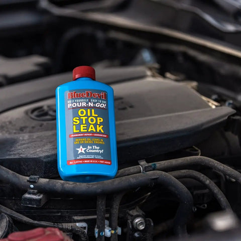 Oil Stop Leak Additive That Actually Seals Leaks Fast, 8 Ounce Bottle on engine with crankcase visible.
