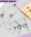 10 Pack 180 Degree Stainless Steel Torsion Springs, 1.5mm Wire Diameter, 15mm Outside Diameter on grey surface