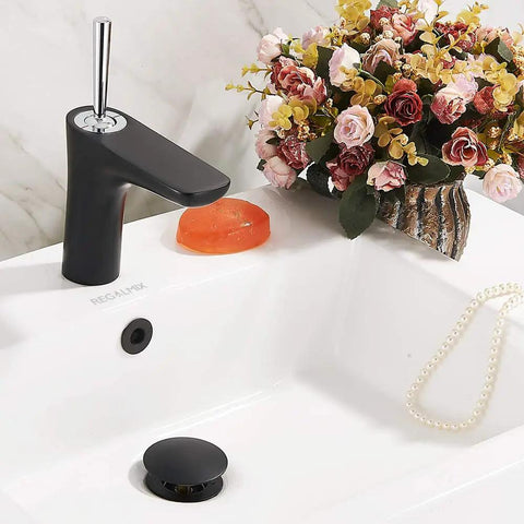 Heavy Duty Matte Black Vessel Sink Drain Stopper With Overflow And Built In Hair Catcher Stops Pesky Clogs Cold And Fits Standard American Sizes For Mess Free Bathrooms Daily in a modern bathroom setting.