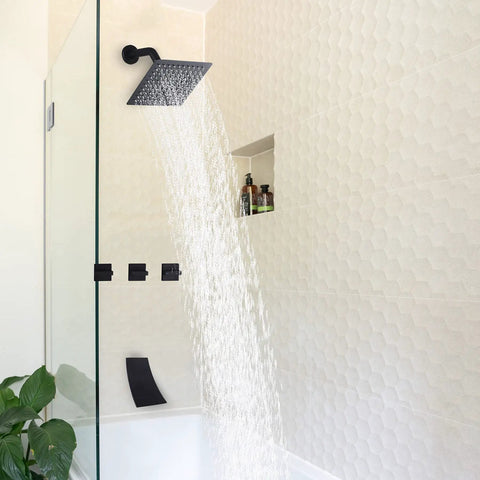 Three Handle Matte Black Tub And Shower Faucet Set With Waterfall Spout viewed in a modern bathroom with glass enclosure