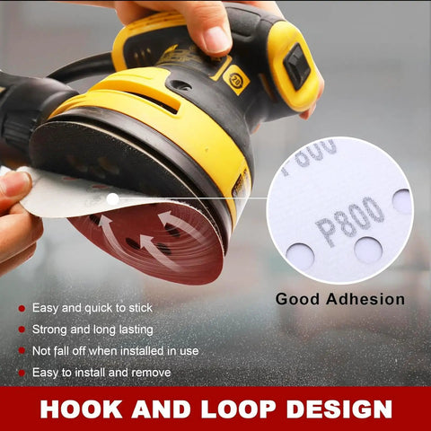 Close-up of DeWalt sander with 52 Piece Sander Pad And Discs Combo Kit With 2 Pack 5 Inch 8 Hole Hook And Loop Pads And 50 Sanding Discs