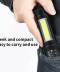 Hand holding 5 Pack Mini Pocket LED Flashlights USB C Rechargeable High Lumens EDC Torch with COB side light in pocket