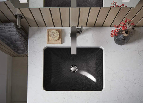 Top view of a modern bathroom sink with Composed Bathroom Towel Arm In Titanium Finish For Sleek Minimalist Look next to it.
