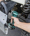 Using 12V Max CXT Impact Wrench Kit With Ultra Compact Six Inch Body on vehicle suspension, ergonomic grip visible