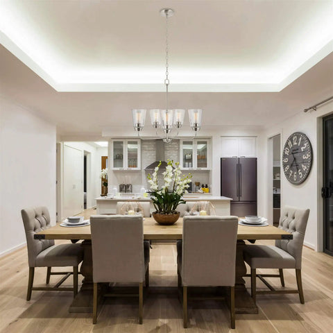 Amara 23 Inch Modern 5 Light Chandelier With Clear Glass Shades Brushed Nickel Finish Adjustable Chain Bright Chic Contemporary Ceiling Fixture For Living Room Or Dining Area in dining room setting