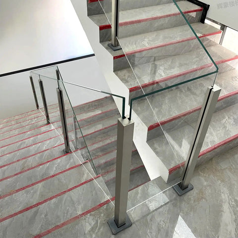 Built Different Stainless Steel Glass Railing Posts With Square Tube Design And Adjustable Heights For Indoor Hallways Outdoor Decks Pool Areas And Stairs Featuring A Rust Proof Brushed Finish That Keeps Your Property Secure And Looking Slick on modern staircase.