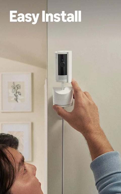 Man installing the Sleek 360 Degree Pan Tilt Indoor Security Camera With Crisp Hd Video And Two Way Talk on a wall.