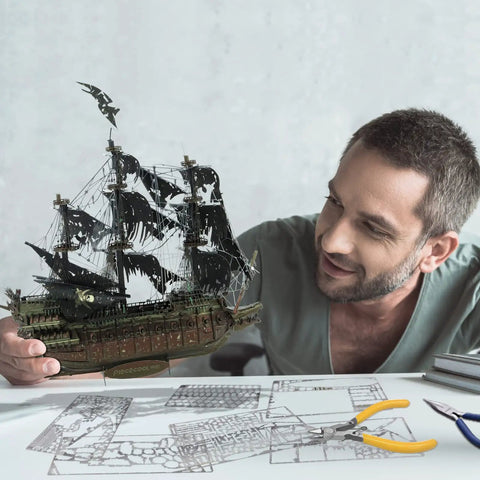 Man assembling Epic Dope 3D Metal Puzzle Kit Flying Dutchman Pirate Ship Model Building Set For Adults And Teens Challenging DIY