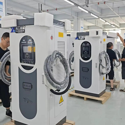 Heavy Duty EV Fast Charger With Kickin DC Fast Charging System And Rugged Steel Cabinet Built Tough For Big Rig Depots And Job Sites Featuring No Sweat Weatherproof IP54 Housing GBT Plug And Keyless Fob Access, displayed in a factory setting.