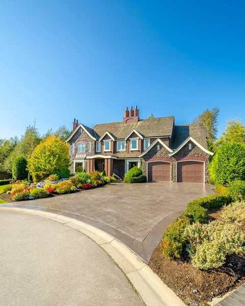 Top Shelf Pro Grade High Gloss Wet Look Concrete Sealer That Really Gonna Make Your Driveway Shine With Hard Hitting Protection And Deep Color Enhancement For A Solid Five Gallon Finish on a decorative driveway.