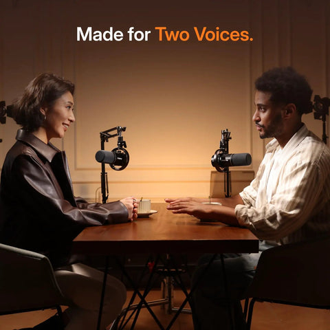 Two people at a table using Hybrid Wireless Podcast Microphone With USB And XLR For PC Mac Phone Tablet, dynamic mic setup.