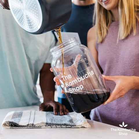 People pouring liquid into jar for 100 Percent Organic SCOBY Kombucha Starter Kit For Home Brew Sessions With Live Culture And Starter Liquid