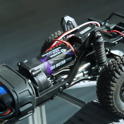 Close-up of 180 Pro Brushed 48T Motor for TRX4M 1 18 Scale RC Crawler with wiring and suspension components visible.