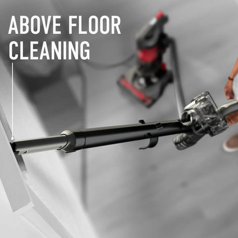 Hoover Rewind Pet Upright Bagless Vacuum Cleaner For Carpet And Hard Floors With Automatic Cord Rewind And Above Floor Cleaning Capability In Sleek Gray Finish, demonstrating above floor cleaning feature.