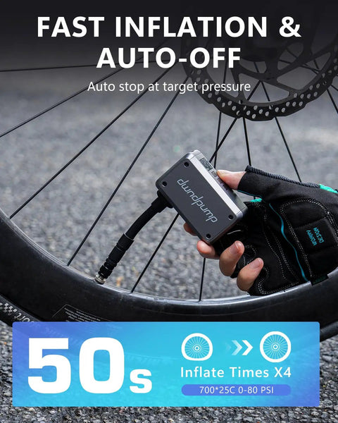 Cyclist using Mini Bike Pump With Gauge And Auto Shut Off For Road And Mountain Bikes On The Go near bike wheel, fast inflation in 50 seconds.