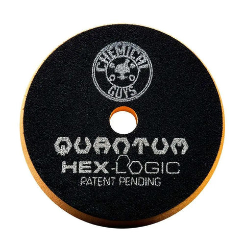 Close-up of Hex-Logic Quantum Buffing Pad with Chemical Guys logo, showcasing pad texture and lettering on black surface.