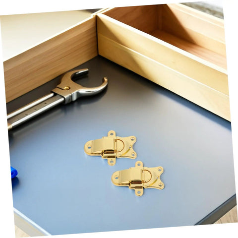 Stylish Vintage Zinc Alloy Duckbill Toggle Latch Set With All Mounting Hardware For Upgrading Wooden Jewelry Boxes And Cabinets In Super Cool Golden Finish You Will Love on a gray surface with tools.