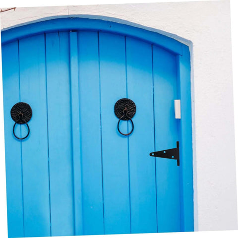 Heavy duty outdoor gate hinges installed on a blue door
