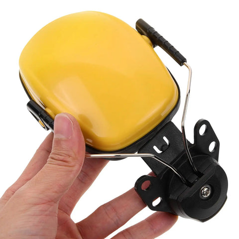 Heavy Duty Hard Hat Earmuffs With Hella Thick Sponge Cushions For Kickass Noise Reduction And Reliable Hearing Protection On Any Big Construction Jobsite Today held in hand, showcasing yellow ear cup and mounting clip.