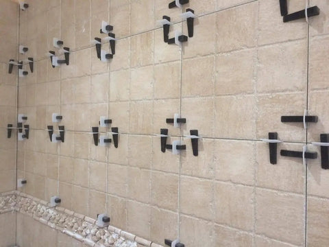 Tile wall using White 1mm Tile Leveling System Tabs Pack Of 500 For Perfect Flat Installs to prevent lippage during mortar setting.
