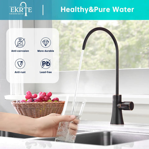 Oil Rubbed Bronze Water Filter Faucet For Under Sink Commercial Reverse Osmosis Spigot Lead Free 304 Stainless Steel With Ceramic Valve Core No Fuss Easy Install Drinking Water Purifier Faucet with hand pouring water into glass next to basket of fruits.