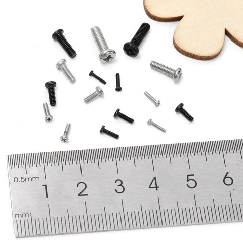 Built Tough Black Carbon Steel Phillips Pan Head Machine Screws 1200 Piece Heavy Duty Tiny Bolt assortment with ruler for size reference.