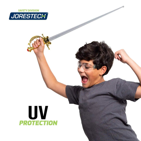 Kickass Kids Safety Glasses Featuring Hella Clarity Impact Resistant Polycarbonate Lenses With Heavy Duty UV Blocker For Daily School Use And Tough Playgrounds Alongside Anti Scratch Frameless Comfort worn by smiling child holding a toy sword.