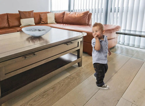 Premium Soft Foam Corner Protectors Grey Four Pack Furniture Edge Guards No Mess Setup And Secure Fit Shock Absorbing Bumpers For Glass Tops Desks And Baby Proof Interiors in a childproof living room.