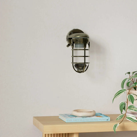 Industrial 100W Incandescent Wall Mount Light in Antique Brass with tempered glass and protective cage on wall