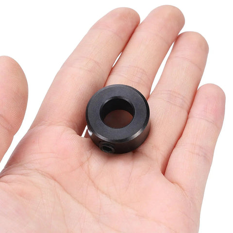 Four Pack Set Screw Shaft Collars Seven Sixteenth Inch Bore Carbon Steel With Seven Eighth Inch Outer Diameter And Seven Sixteenth Inch Width Black Oxide Finish Built Tough For Linear Rods And Shafts Axle Clamp held in hand