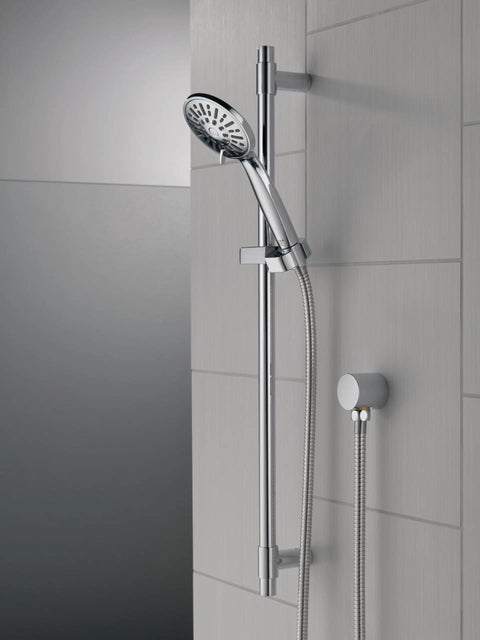 Solid Chrome Handheld Shower Head With Slide Bar Kit featuring the chrome finish and detachable hose against a gray tiled wall.