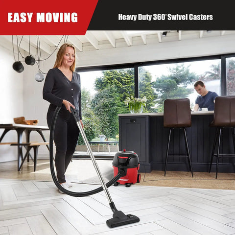 Woman using Corded Canister Vacuum With Bag, 3 Gallon Capacity, 26 Foot Cord, One And A Quarter Inch Hose on hardwood floor