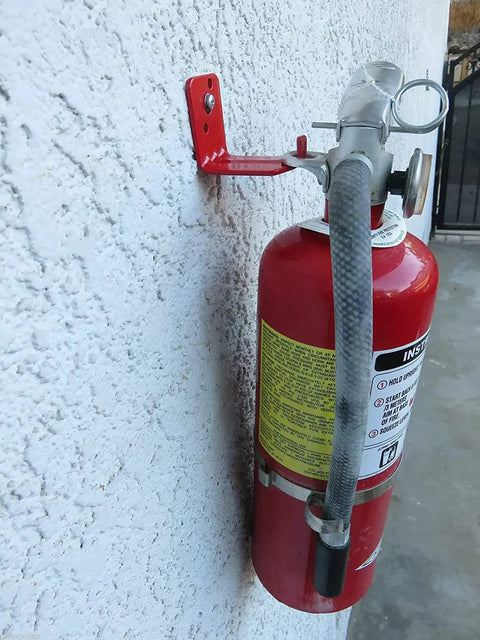 Rugged L Hook Fire Extinguisher Bracket Mount Kit For 15 To 40 Lb Extinguishers Wall Hanger Brackets Four Pack Heavy Duty Iron Construction Easy Install Fits Most Units holding red extinguisher