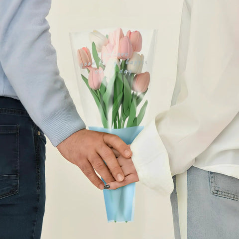 Couple holding a bouquet in 150 Pack Flower Bouquet Sleeves With Plastic OPP Wrapping Bags, DIY Friendly Protective Floral Packaging For Bouquets