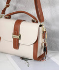 Tan and cream handbag with gold hardware, featuring the 16 Piece Locking Brass Carabiner Key Ring Set With Screw Lock Clips attached.