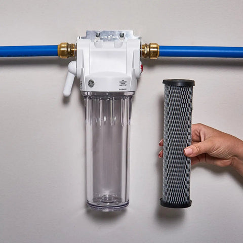 Two Pack Whole House Water Filter Replacement For 10 Inch By 2.5 Inch Systems NSF Certified with hand holding filter near housing